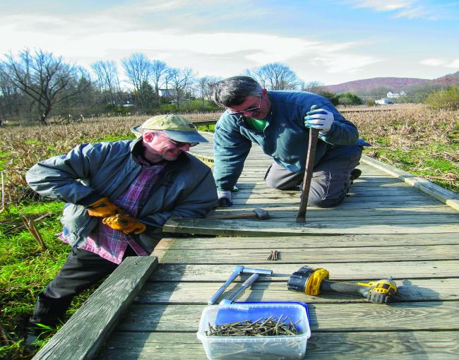 West Jersey Crew Chief David Day and crew member Pete Zuroff work on repairing old decking on the Pochuck Boardwalk. Photo by Georgette Weir.